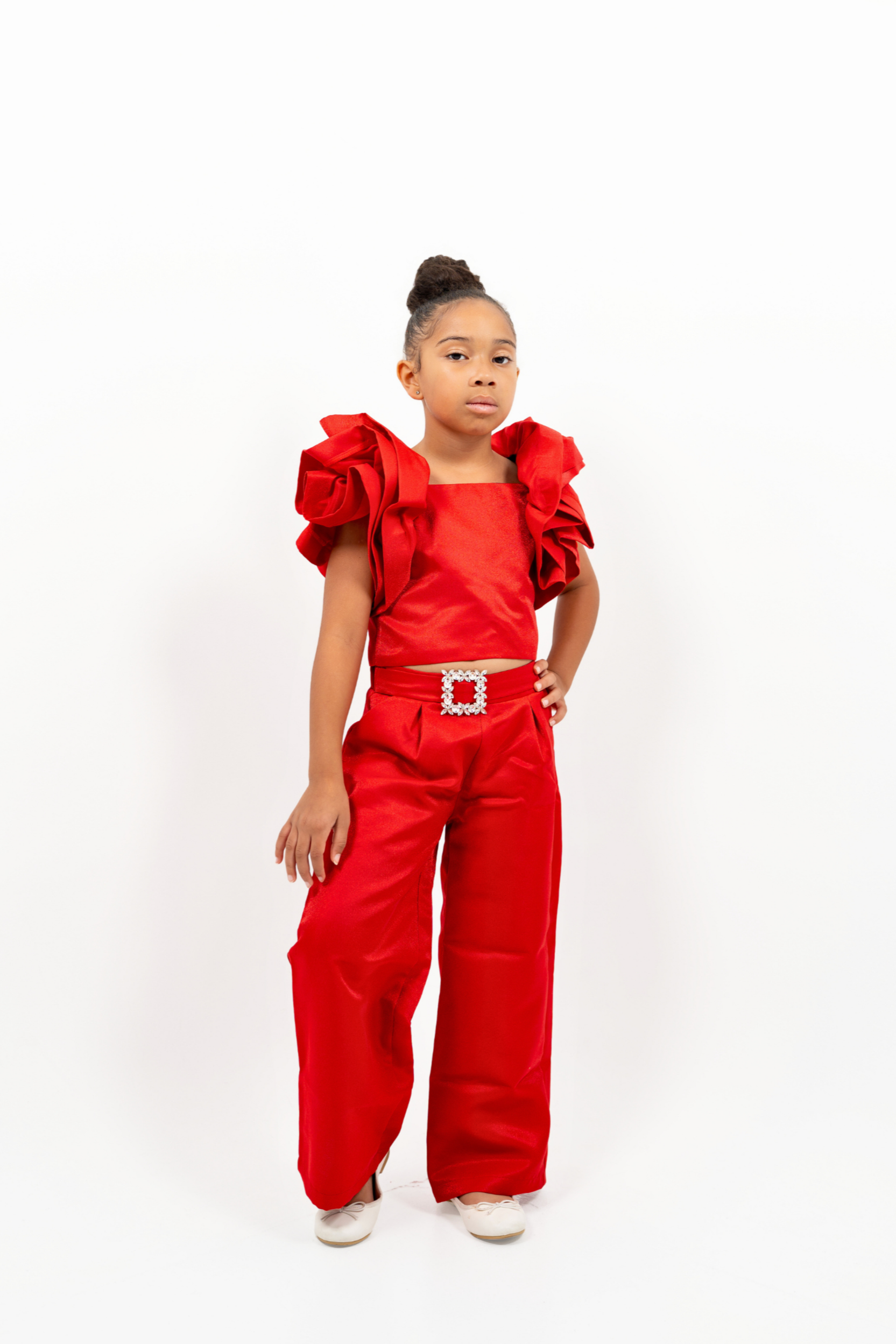 Girl in red shimmer pantsuit with ruffled sleeves and rhinestone belt – festive occasion outfit for toddler and girls